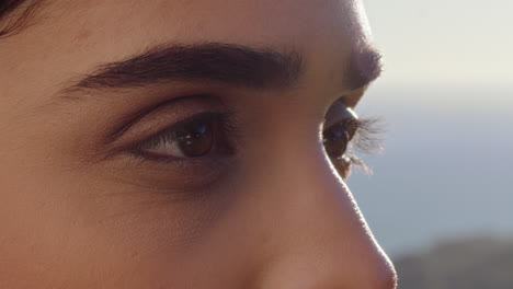 close up of beautiful eyes woman enjoying view relaxing on summer vacation contemplating future looking at sunny outdoors