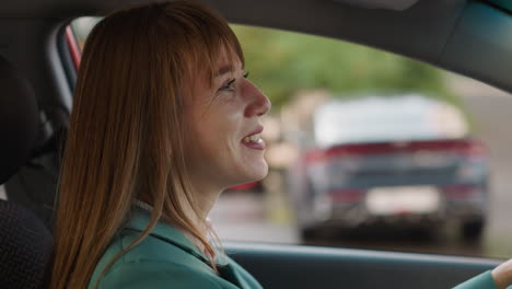 happy woman smiles listening to music while driving car