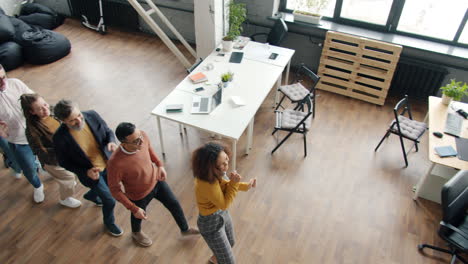 happy employees celebrating success in modern office