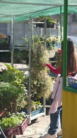 woman watering plants at a flower market