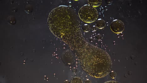 glittering golden liquid, bubble shapes, spreading patterns, slow motion