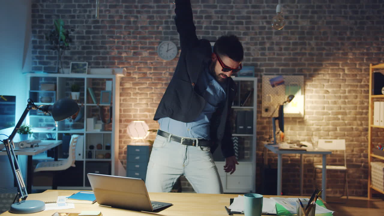 Man Dancing in Office at Night