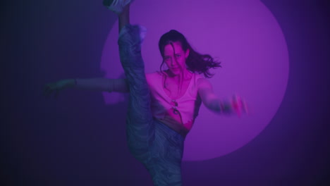woman dancing in a purple neon light