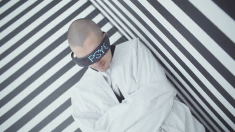 man in a straight jacket with digital display glasses