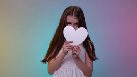 young girl holding a white heart