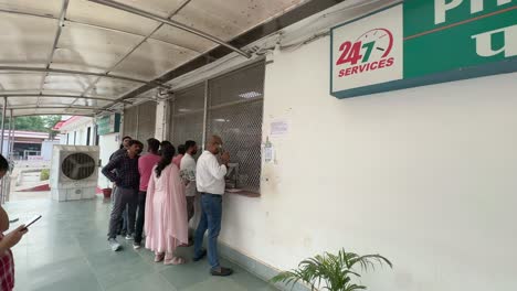 people waiting in line at a 24/7 pharmacy in india