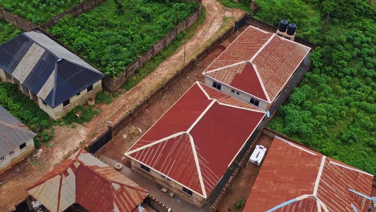 Aerial of houses with walls around them in a rural community in Nigeria, Africa