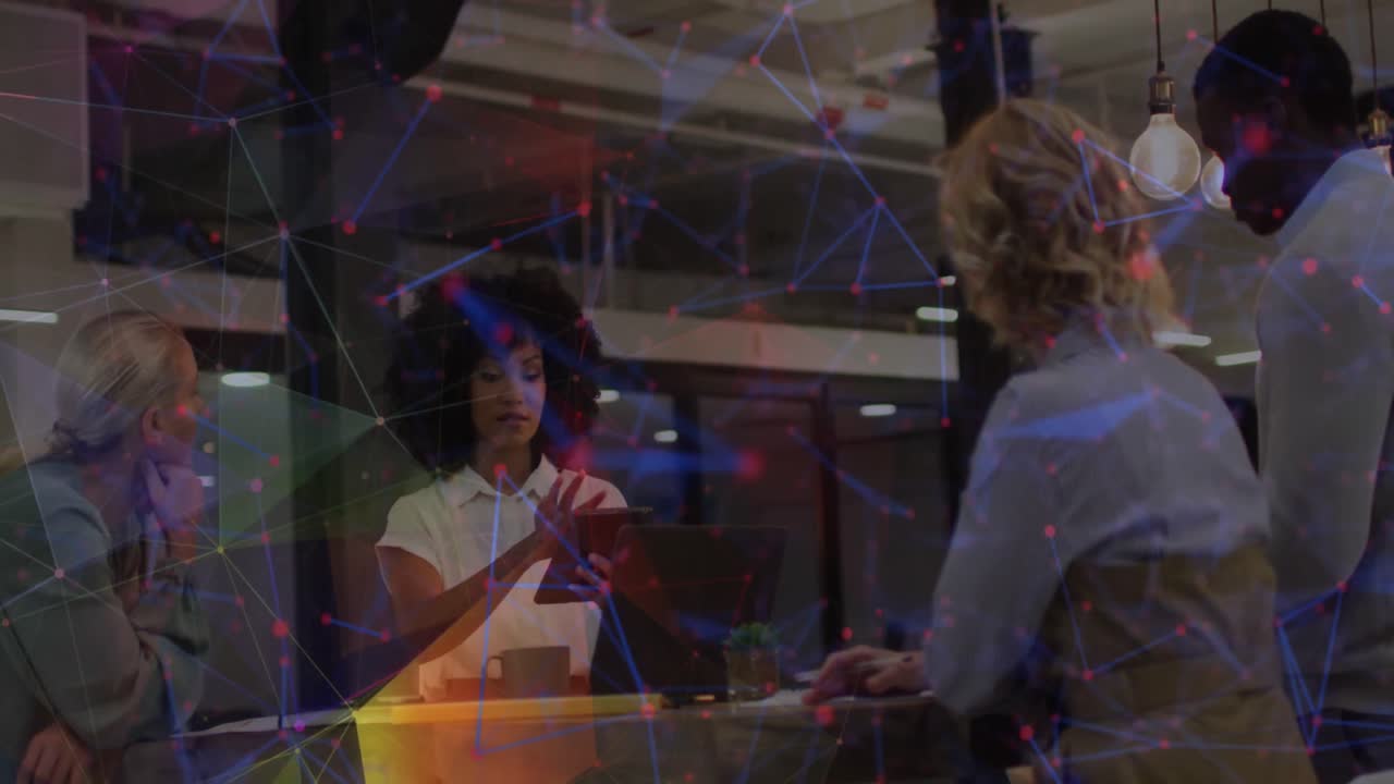 Animation of colourful network over diverse business colleagues in office meeting