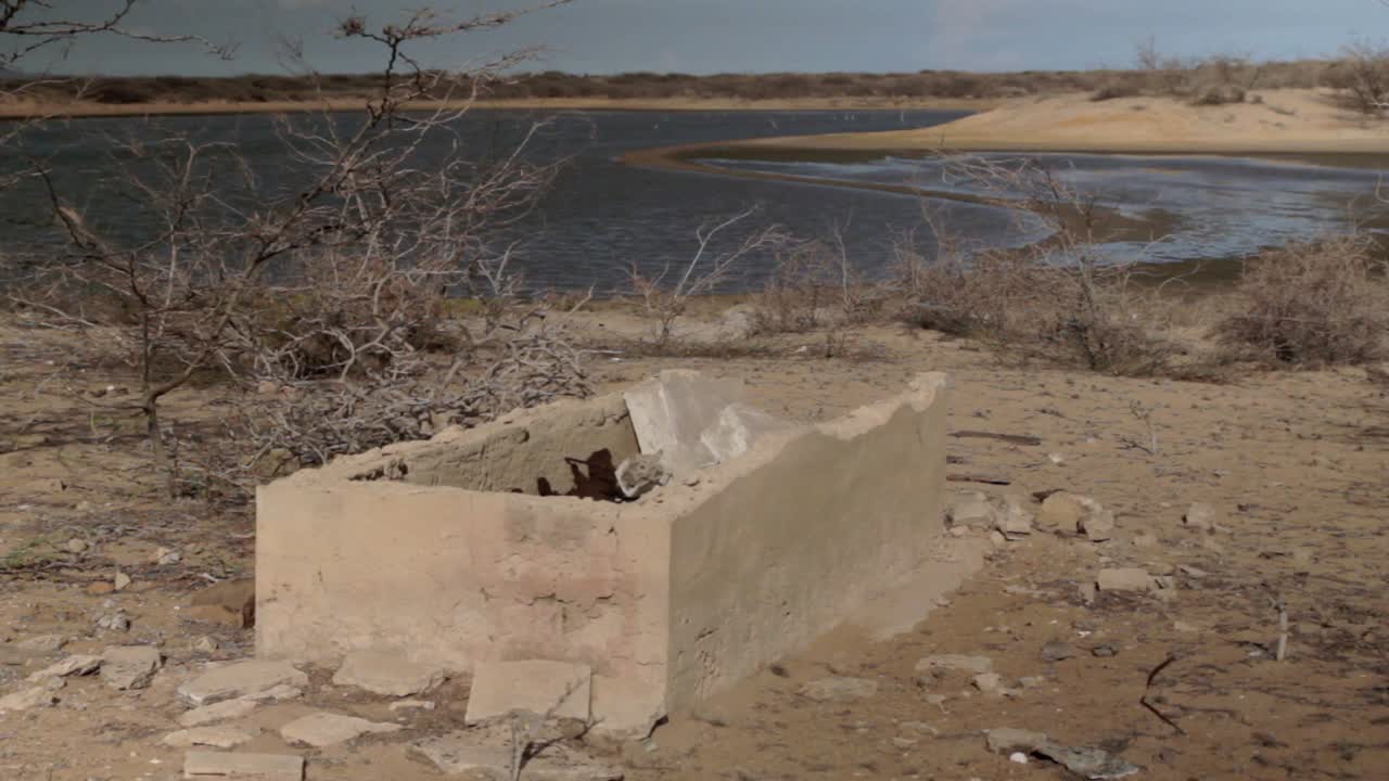 Arid landscape with lake and ruins