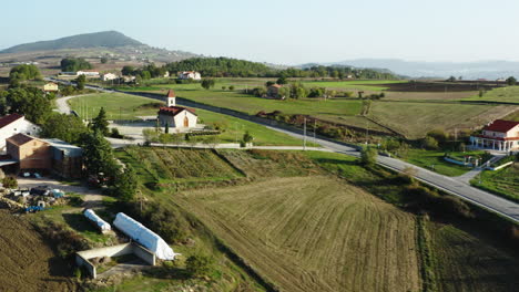 wide aerial shot of a small black car driving through molise region in italy