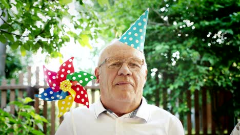 portrait of a happy elderly man with a festive cap on his head