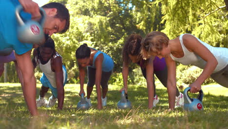 In-high-quality-format-fitness-group-planking-in-park-