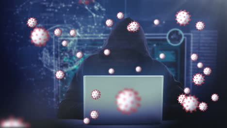 animation of of macro covid19 cells over man wearing hoodie, using a laptop