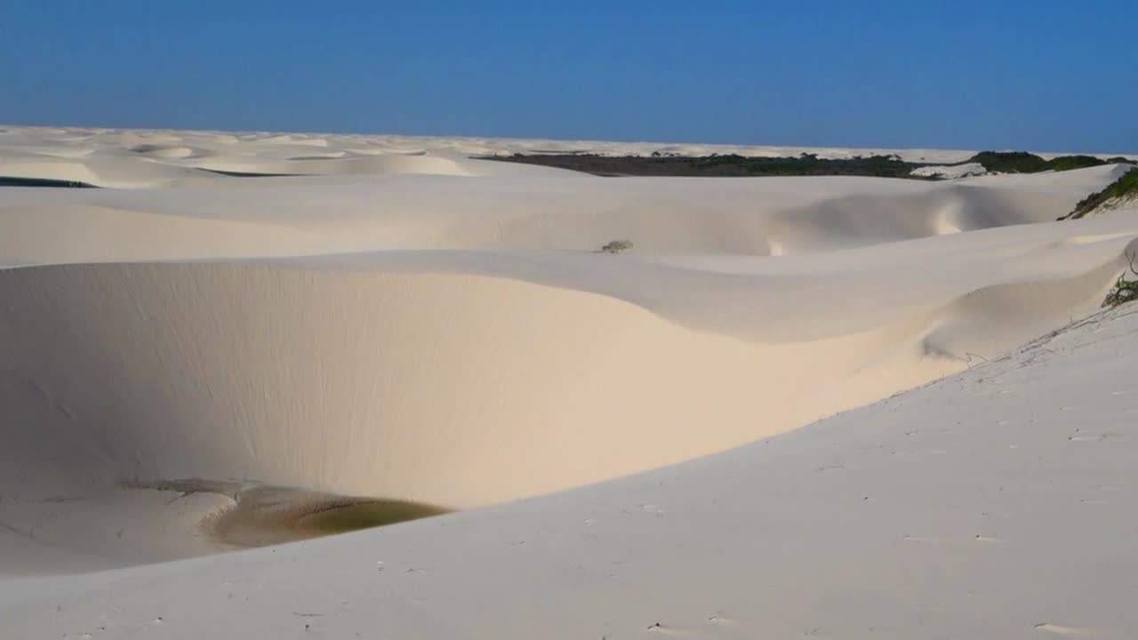 Tourist people walking in dune of Lençóis Maranhenses National Park.