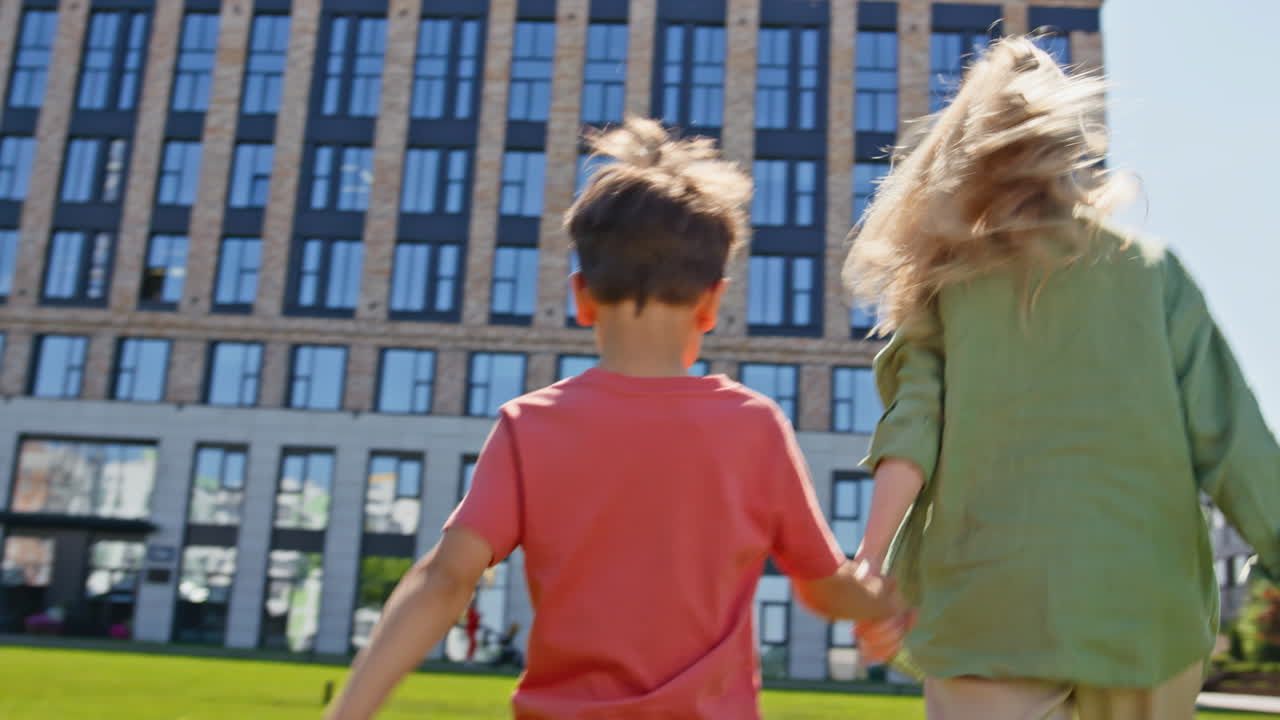 Emotional mother walking meadow high building closeup. Woman son having fun