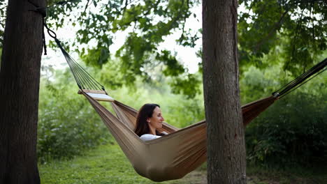 woman relaxing peacefully in a hammock outdoors