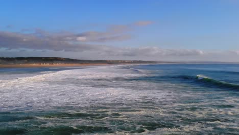 Drone-footage-of-some-waves-rolling-in-by-the-beach