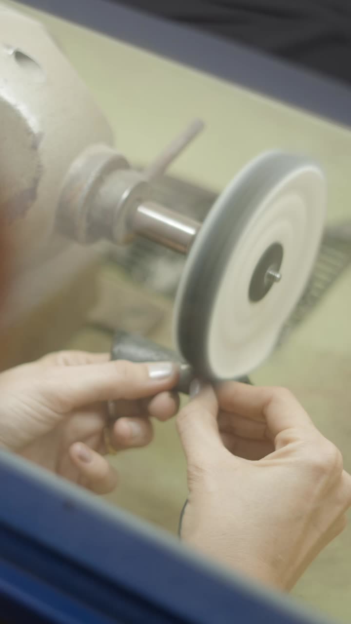 Hands Polishing a Metal Object with a Buffing Machine