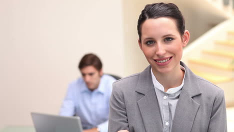 una joven mujer de negocios sonriente de pie.