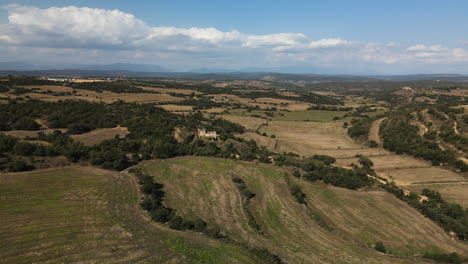 uncultivated fields in lleida with a farm house in the middle