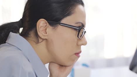 business woman standing inside an office building.