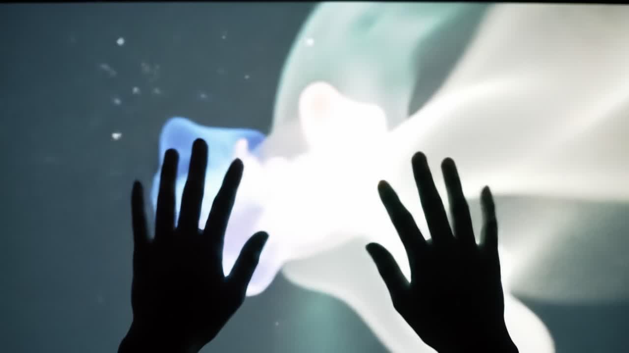 Visitors interact with a stunning display of colorful light and flowing shapes as they explore the unique exhibit designed to captivate senses. The experience immerses people in creativity.