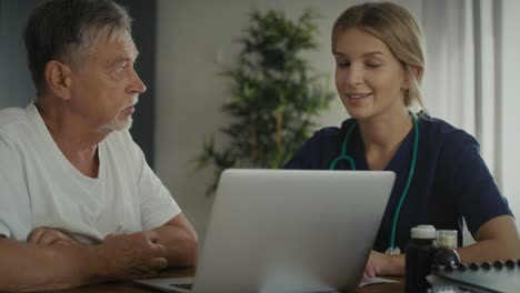 caucasian female doctor analyzing medical tests with senior patient at home visit.