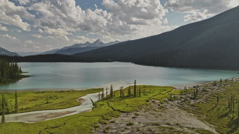 Emerald-Lake-BC-Canada-Aerial-v11-cinematic-drone-flyover-capturing-river-water-flows-into-the-lake,-pristine-calm-waters-within-lush-mountain-forest-valley---Shot-with-Mavic-3-Pro-Cine---July-2023