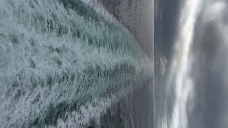 watching the wake on a cruise ship on a cloudy, moody day - vertical orientation