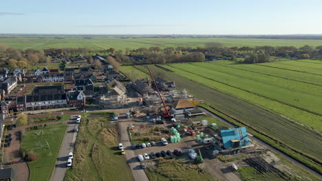 aerial overview of a busy construction site near a modern suburban neighborhood