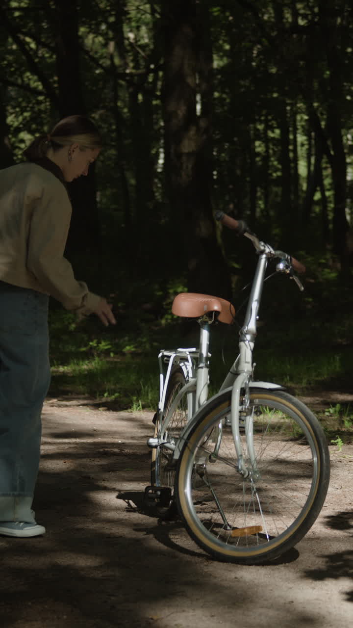 Woman with a Bicycle in the Forest