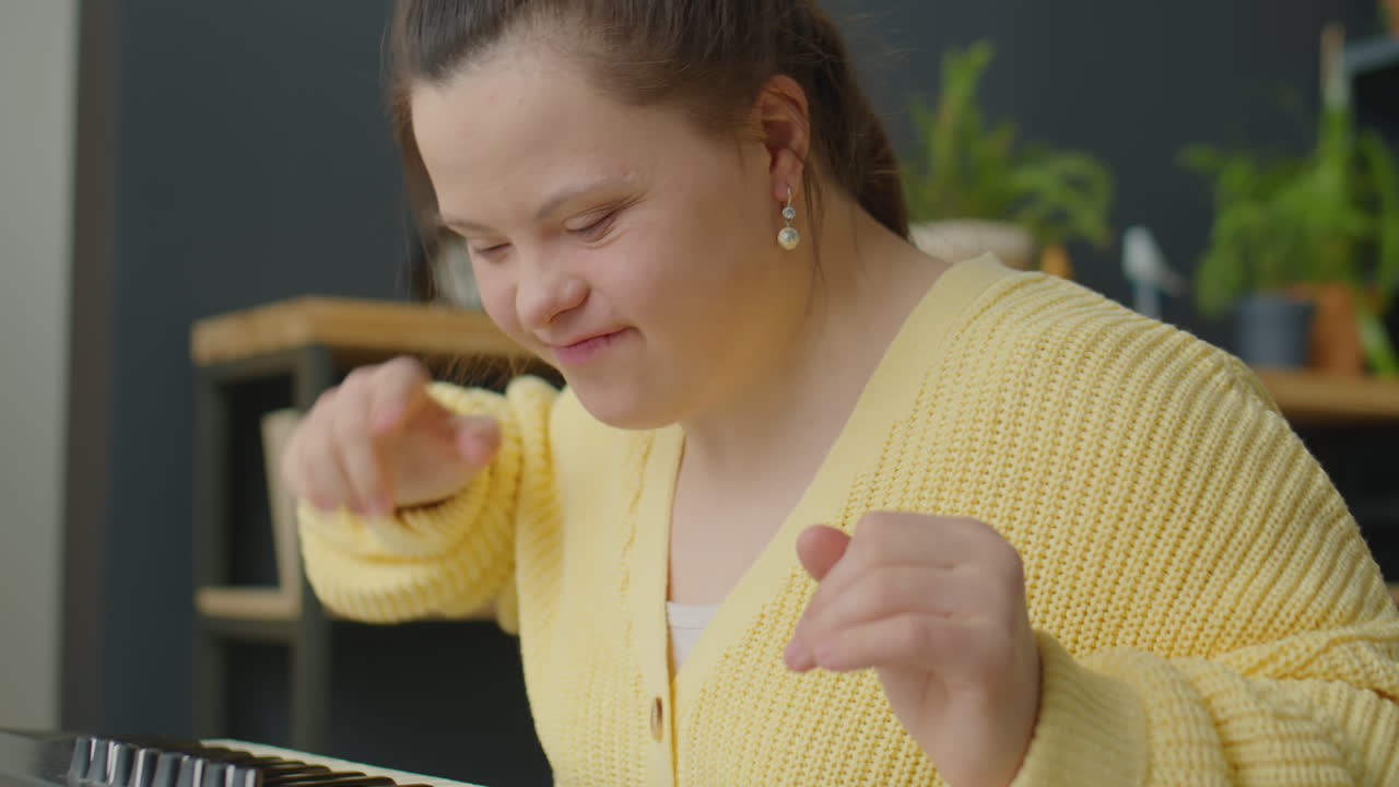 Joyous Girl with Down Syndrome Playing Synthesizer