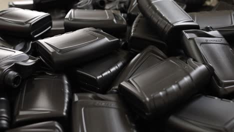 pile of black plastic oil bottles