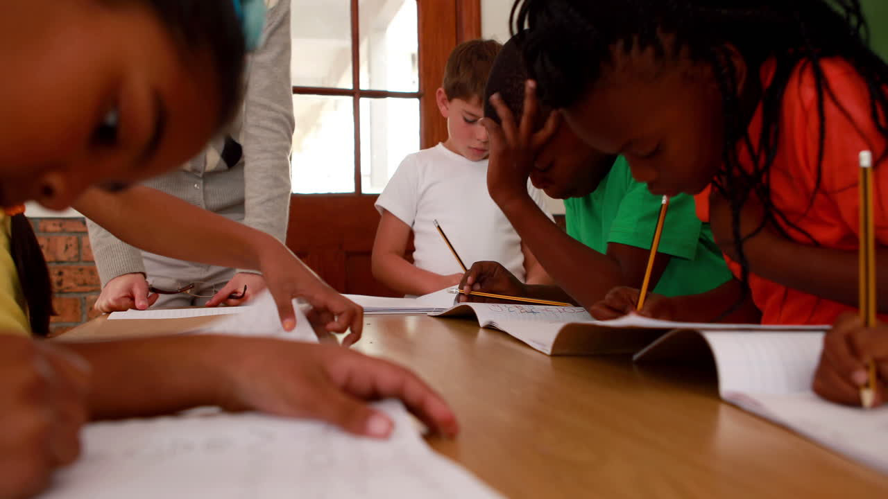 Pupils all working at the same desk in classroom