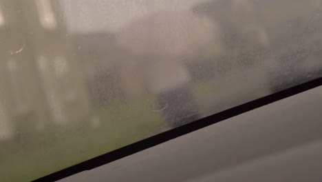 woman with umbrella in heavy rain pov of windscreen