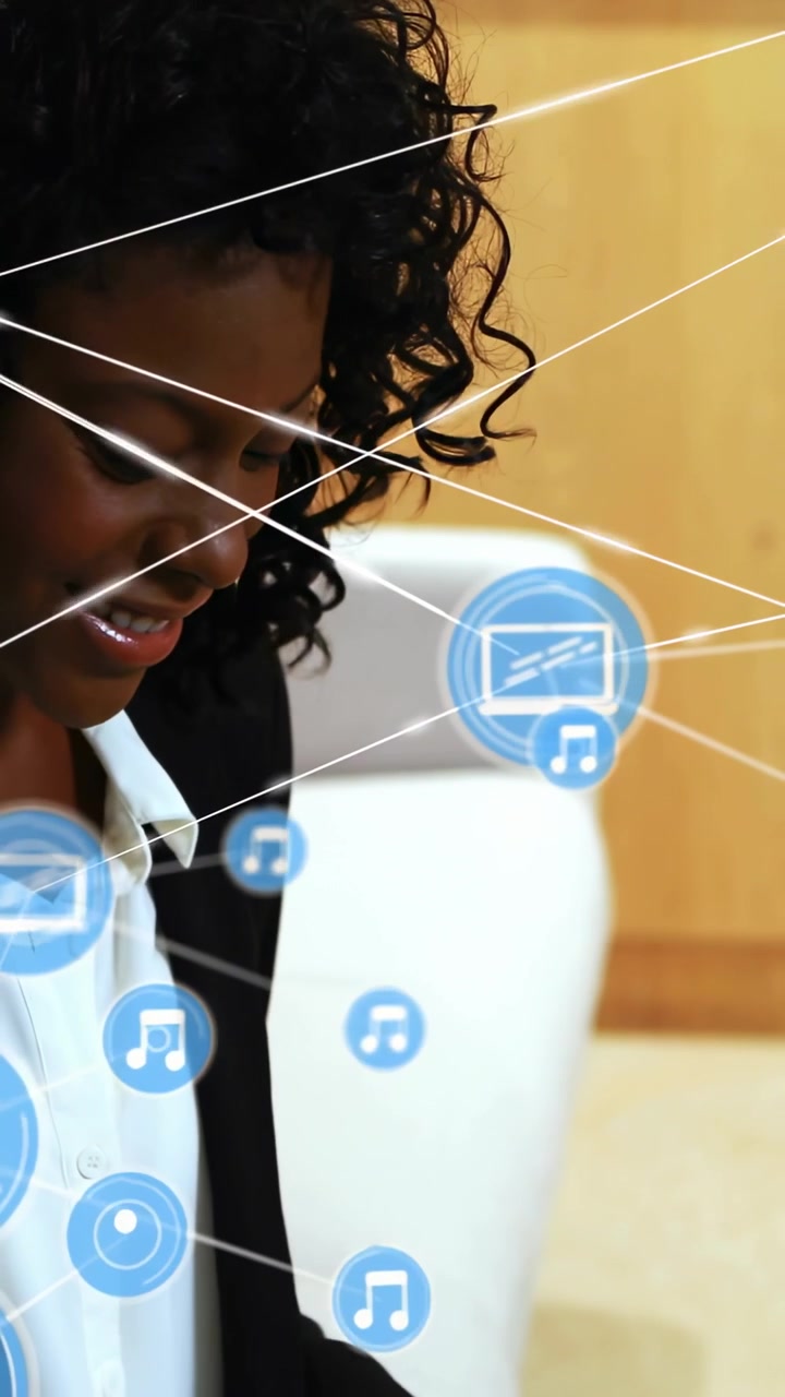 Vertical video: Woman typing on laptop, initiating blue media icons appearing, connecting via lines