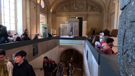 people ascending and descending museum stairs