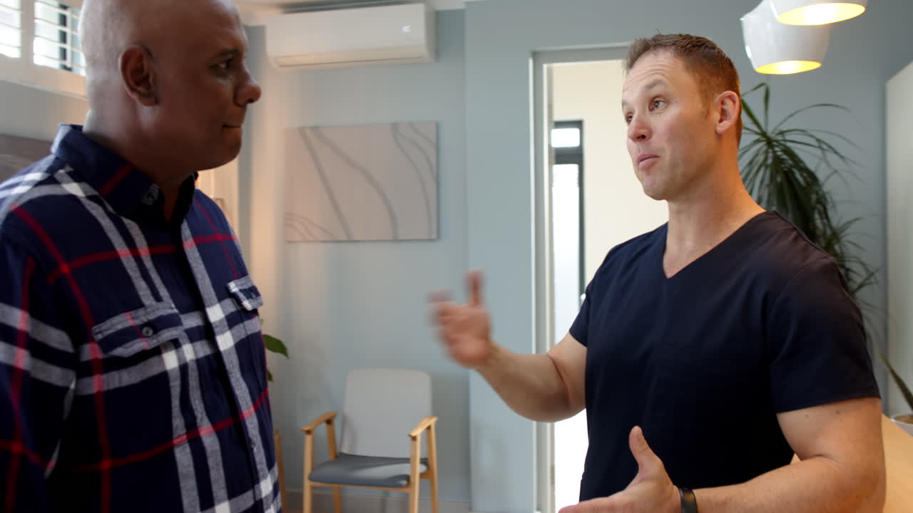 Discussing prosthetic options, doctor and patient having conversation in modern clinic