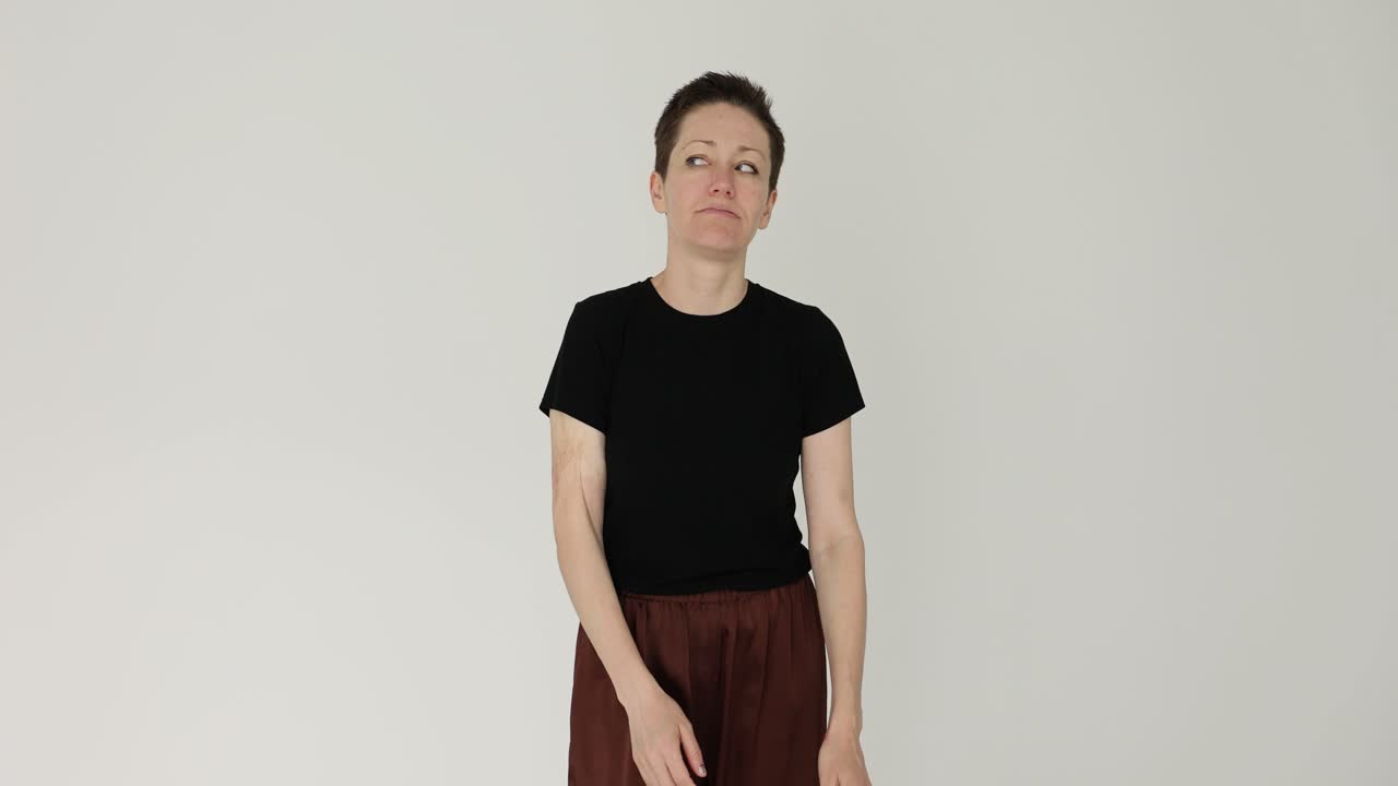 A woman in a black t-shirt and brown pants