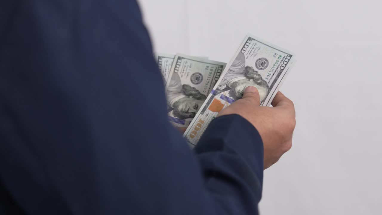 Man flipping through cash banknotes financial transaction and savings concept 4K Video
