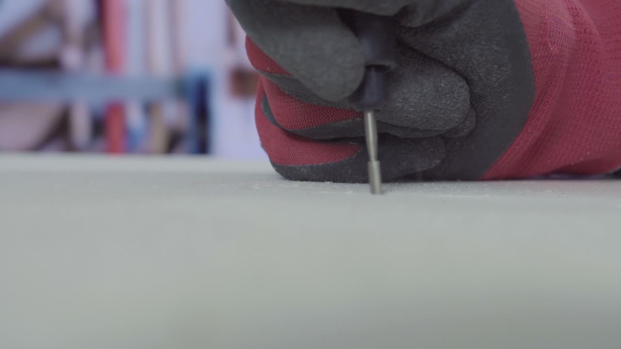 Man work on wood with small rotating rasp 4K