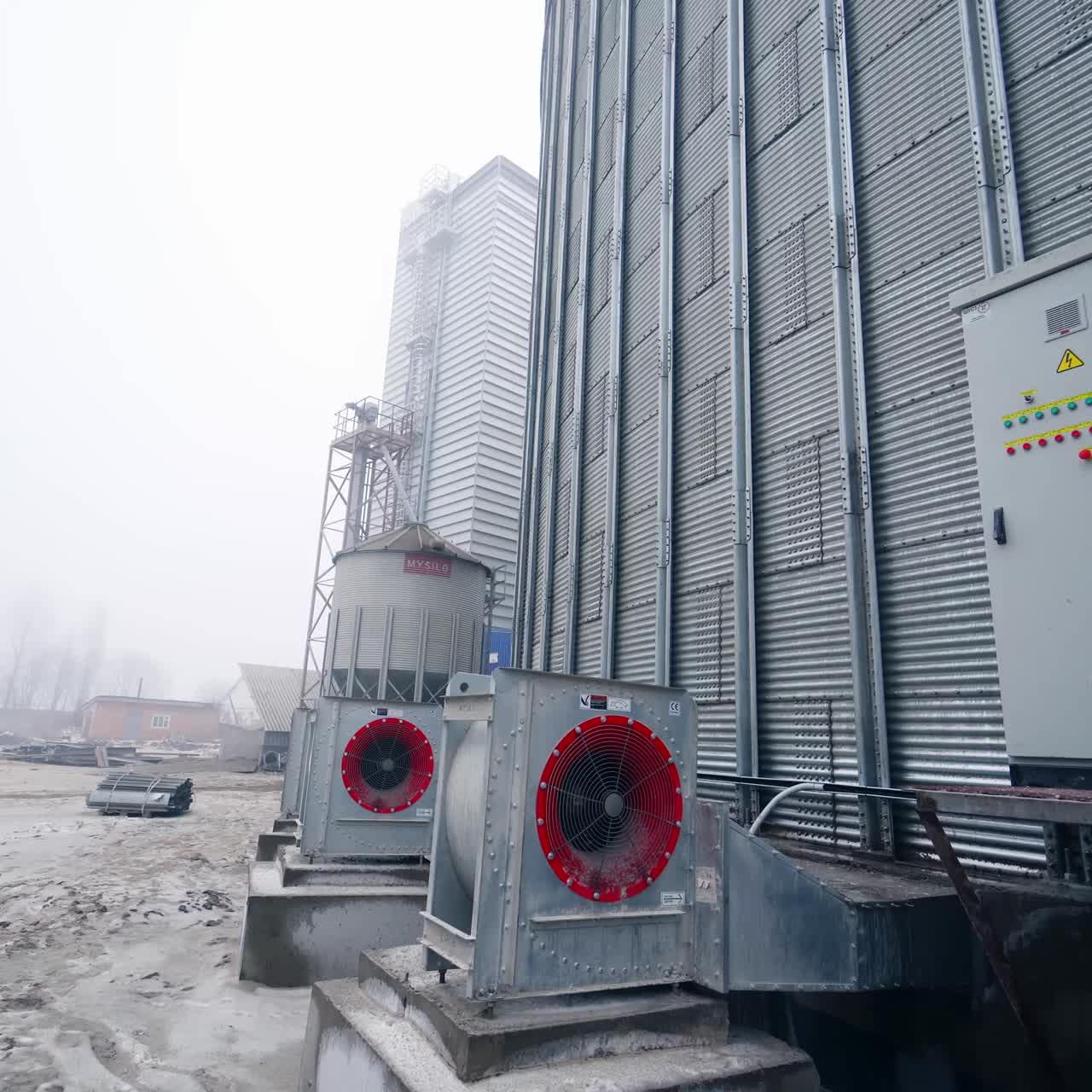 Large silver granary. Storage of grain in the background of winter