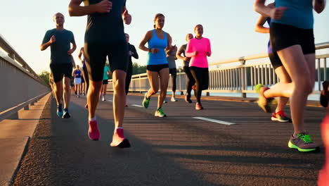 group of runners exercising on a bridge at sunrise or sunset