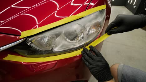 headlight polishing, processing of car lights. a car service worker polishes the headlight of a passenger car. professional polishing.