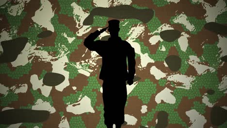 silhouette of soldier saluting against camouflage background