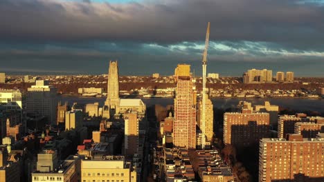 gorgeous slow drone slide along the skyline of the morningside heights neighborhood in manhattan, new york city at golden hour sunrise