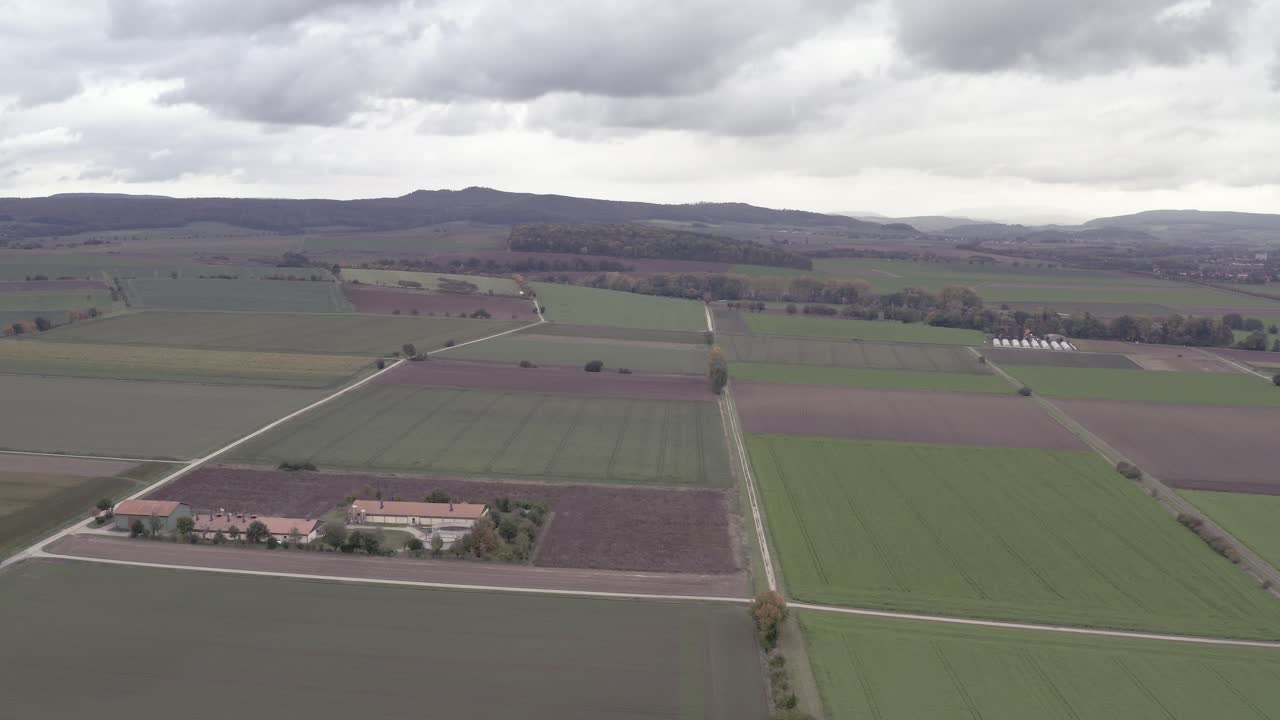 A german farmer is harvesting his field in late autumn