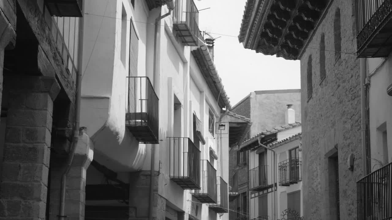 Black and white shot of row of houses in an old town in one of Spain's most beautiful village in Morella, Spain at daytime