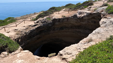 static high angle shot of the opening of benagil sea cave on sunny day