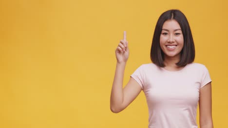 woman with a happy expression, pointing upward